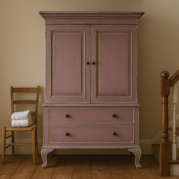 Vintage-style wardrobe with two doors and two drawers in a room with wooden floor and chair.