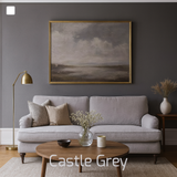 Living room with a grey sofa, wooden coffee table, and framed painting on a dark grey wall.